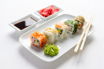 Sushi set on white wooden background