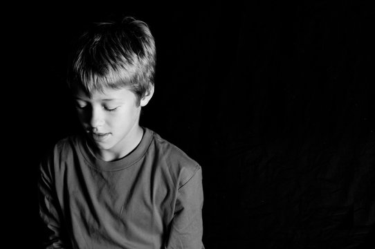 Studio shot of young boy on black background
