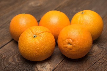 Fresh juicy oranges on the wood background