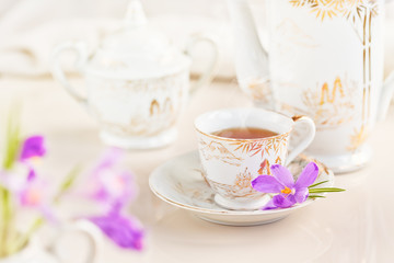 Cup of tea or coffee and crocus flowers
