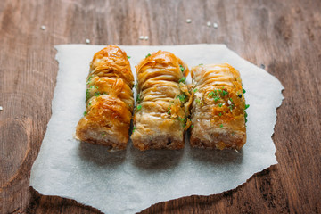 Turkish sweets baklava and tea on a dark background