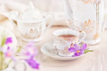Fototapeta na wymiar Cup of tea or coffee and crocus flowers