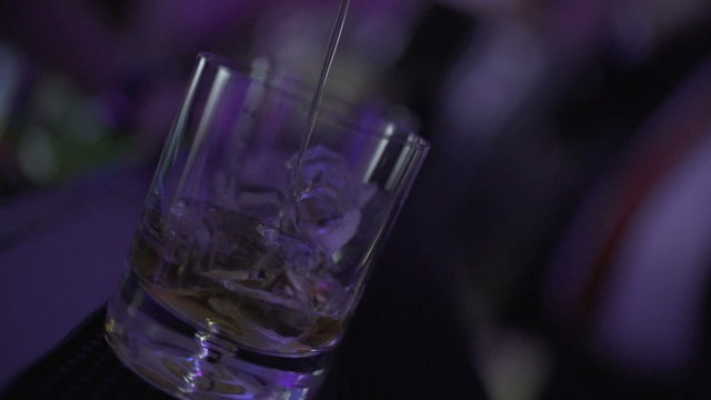 SLO MO CLOSE-UP Liquor pouring into glass
