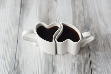 Heart shape coffee cups on wooden table