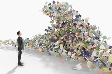 Education concept with businessman looks at the mountain of book