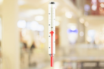 Thermometer with red mercury arrow growing up