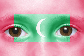 human's face with maldives flag