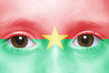 human's face with burkina faso flag