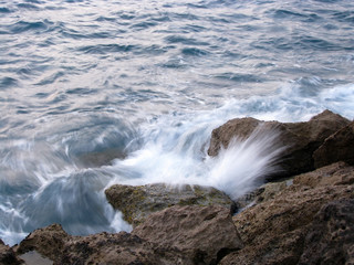 Stones and sea wave splashes