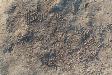 Traces of footwear on a sandy ground. Backgrounds and textures