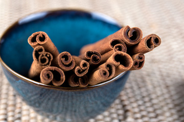 Organic Cinnamon sticks in a blue bowl