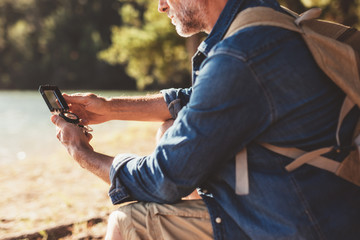 Hiker searching direction with a compass