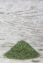 Dried dill herbs over rustic wooden background