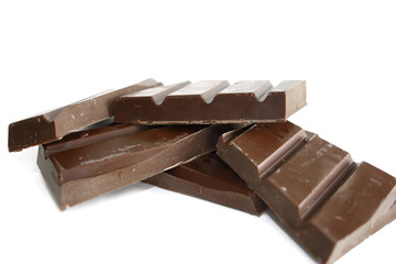 Pieces of dark chocolate isolated on white background

