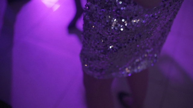 SLO MO CLOSE-UP Woman in purple dress dancing
