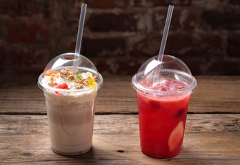 The cocktails in a plastic cup with a straw