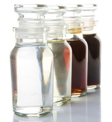 Vinegar, balsamic vinegar, maple vinegar and apple vinegar in glass vial over white background