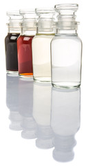 Vinegar, balsamic vinegar, maple vinegar and apple vinegar in glass vial over white background