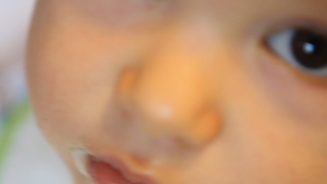 child gnaws empty plastic spoon
