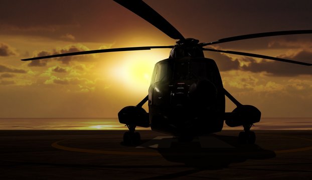 Military helicopter on carrier ship at sunset