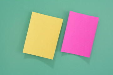 Colorful notes paper on green background