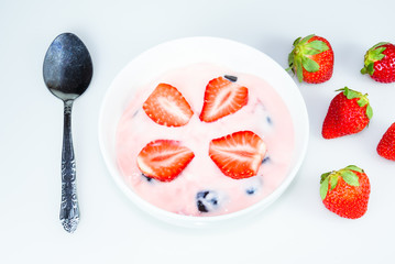 Strawberry and black grape Yogurt in the bowl on the white table