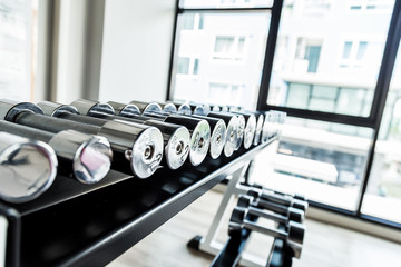 Iron stainless steel dumbbells in fitness gym