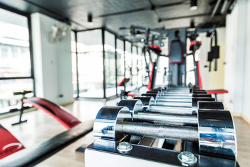 Fototapeta premium Dumbbells weight training equipment in gym close up