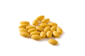 Yellow pills on white background