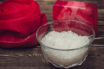 Bath set and essential oil on wooden background