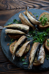 Close-up of sandwiches with smoked sprats, pesto and parsley