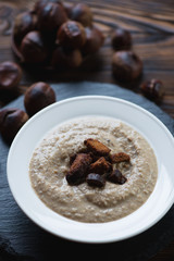 Close-up of chestnut cream-soup with croutons, selective focus