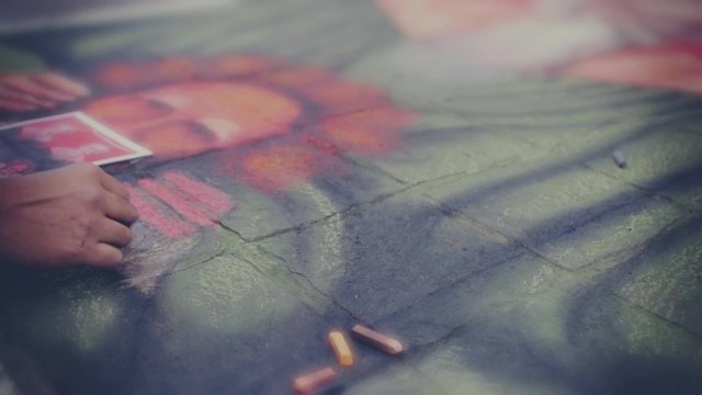 GUANAJUATO, MEXICO - CIRCA DECEMBER 2014: Participants on the painting contest of chalk on the floor during the contest Madonnari 2014