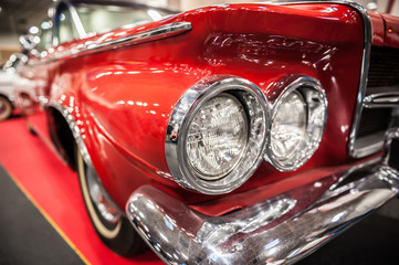 Headlights of a red vintage car - Powered by Adobe