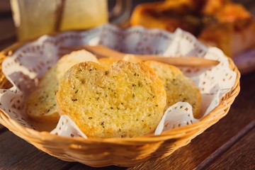 Garlic bread served in baskets on table