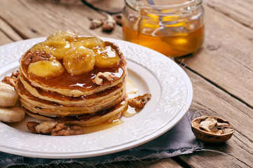 healthy breakfast of pancakes with honey, nuts and caramelized b