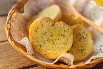 Garlic bread served in baskets on table