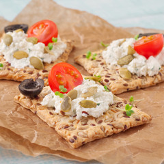 Canape made cookies with cheese, cherry tomatoes and black olive