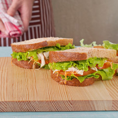 Two big sandwich on a kitchen table