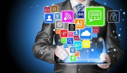 Business man using tablet PC with social media icon set