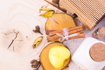  candle, cinnamon with towel on wood