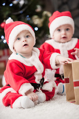 kids dressed as Santa Claus at Christmas tree with gifts

Image ID:168340655