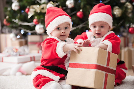 kids dressed as Santa Claus at Christmas tree with gifts

Image ID:168340655