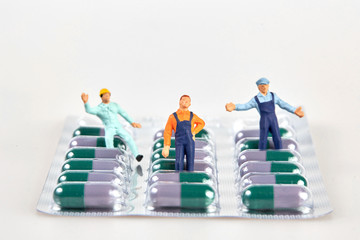 Little figurines on a pill blister