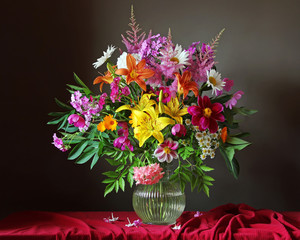 Beautiful bouquet of garden flowers in glass jug
