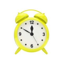 Yellow alarm clock on white