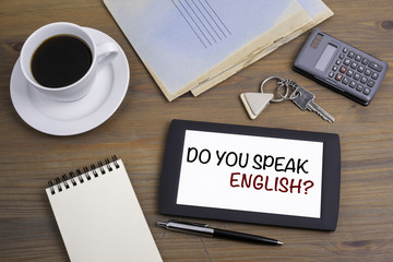 Do you speak english? Text on tablet device on a wooden table