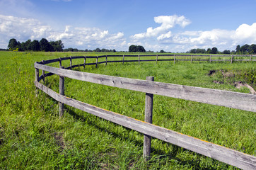 Fototapeta na wymiar Pasture with a wooden fence
