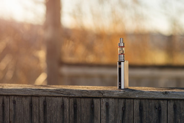 Adjustable electronic cigarette, Non carcinogenic alternative for smoking, sunset in the...