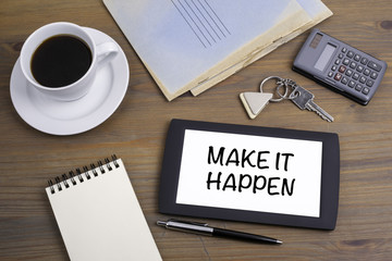 Make It Happen. Text on tablet device on a wooden table